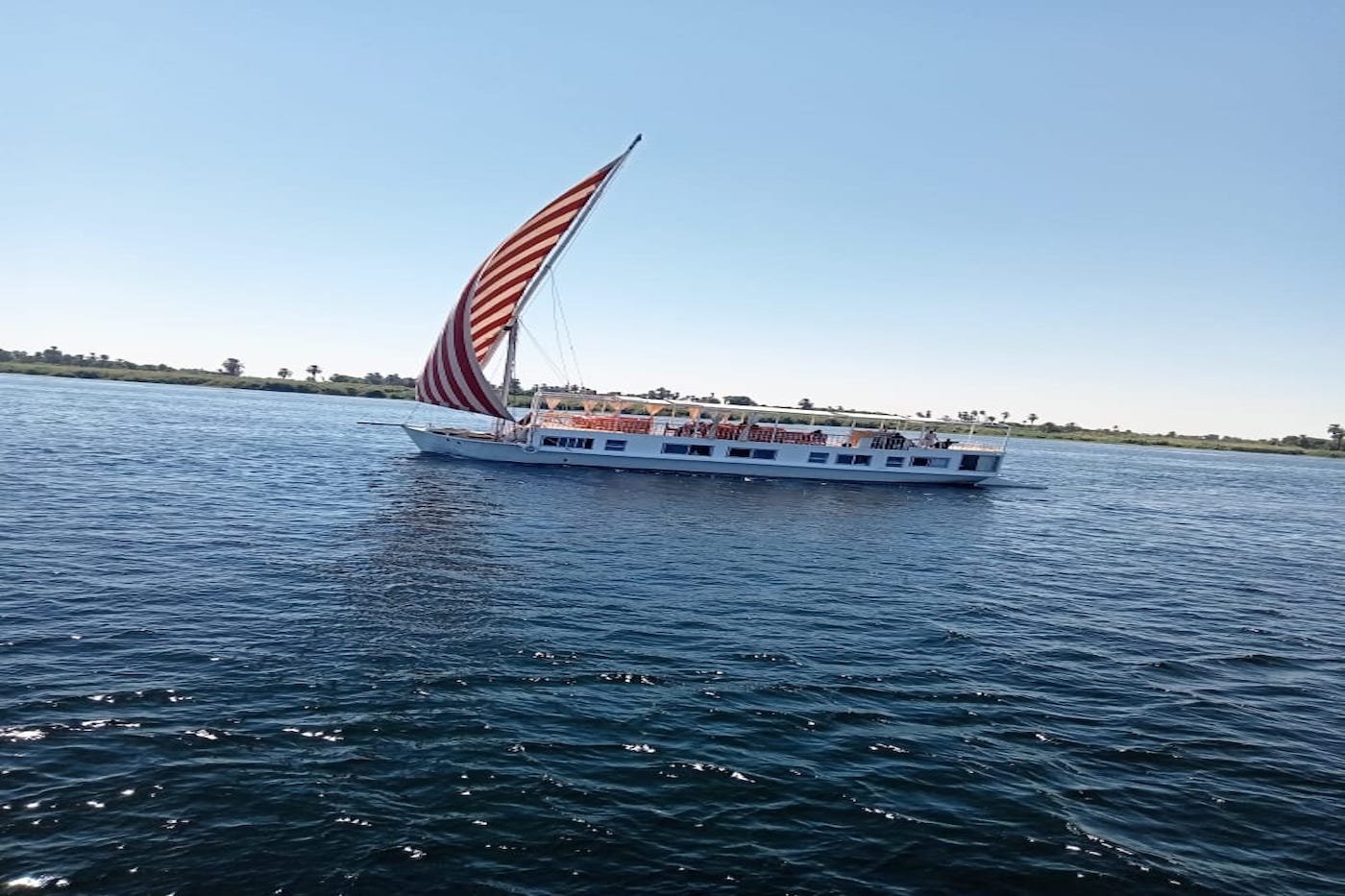 Dahabiya style Nile cruise boat moored on the river